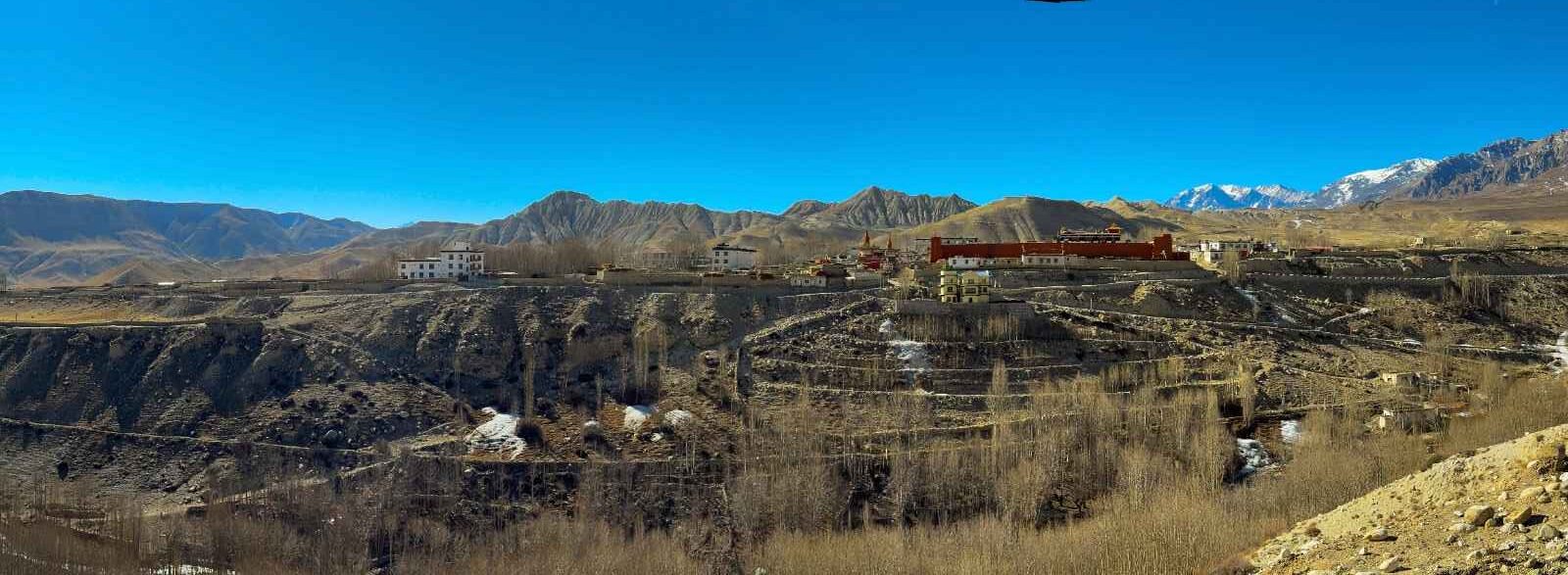 Panoramic view of Lo Manthang, Upper Mustang, Nepal, with mountains and monastery buildings.