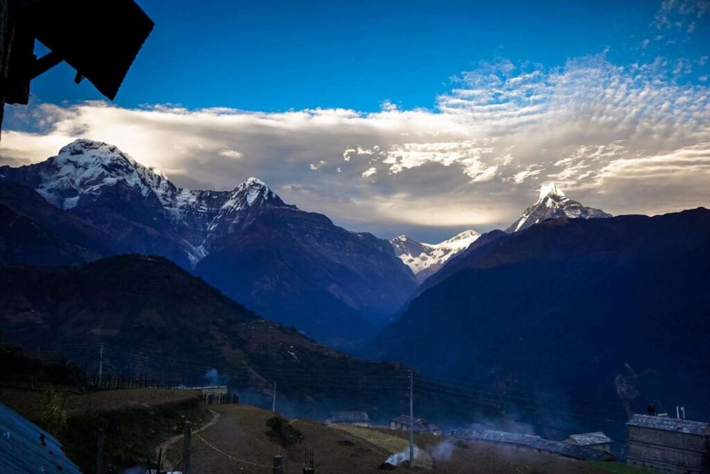 Mountain village view with Machhapuchhre peak under evening clouds