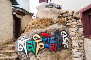 Painted mani stone with Buddhist mantra in an Everest trail village
