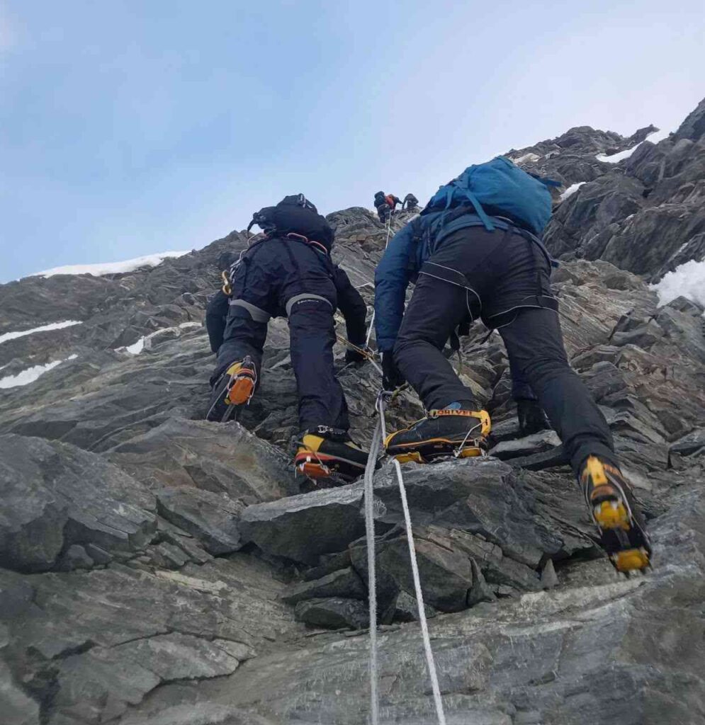 Climbers using crampons on Island Peak rocky ridge